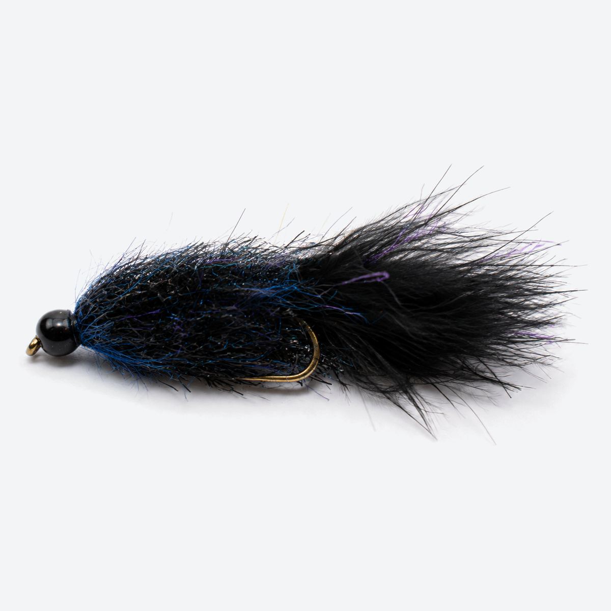 Sparkle minnow black blue fly on a pale studio background