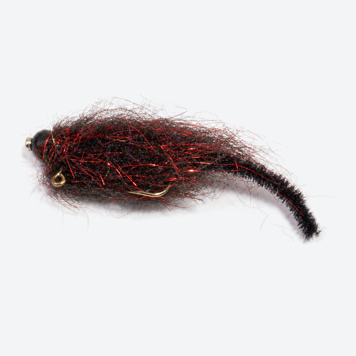 Balanced leech black red fly on a pale studio background