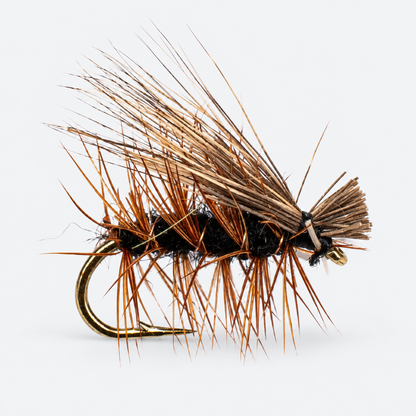 Black Elk Hair Caddis single fly on a pale gray background
