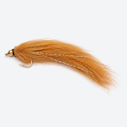 Pine squirrel leech brown fly on a pale studio background