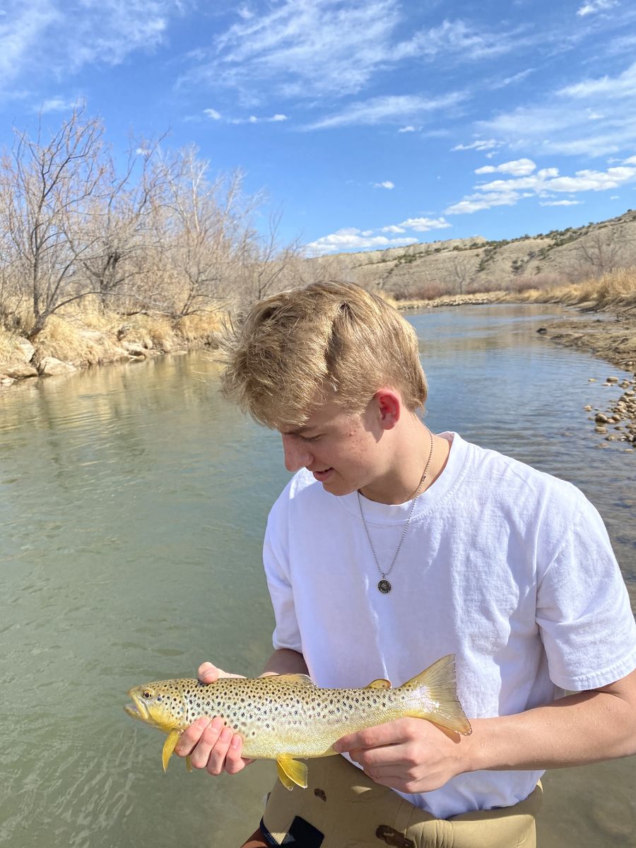 Angler on the riverbank with a catch