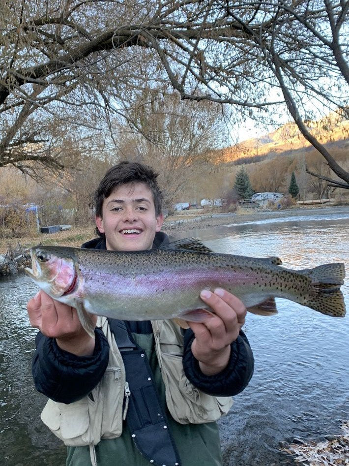 Young angler holding a rainbow trout