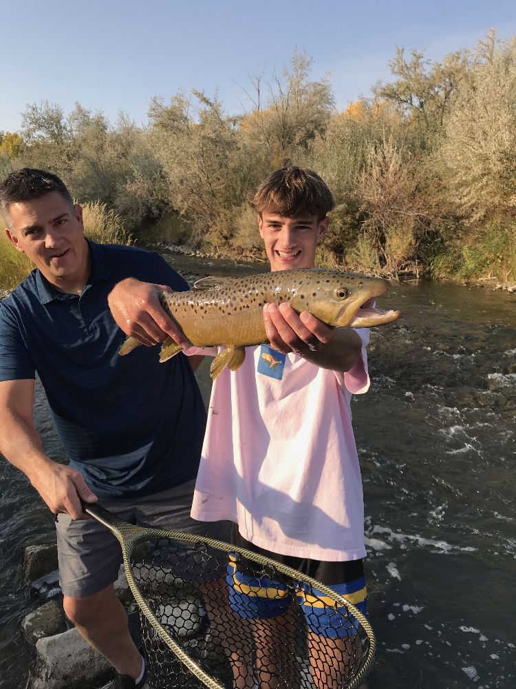 Two anglers with a trout in the net