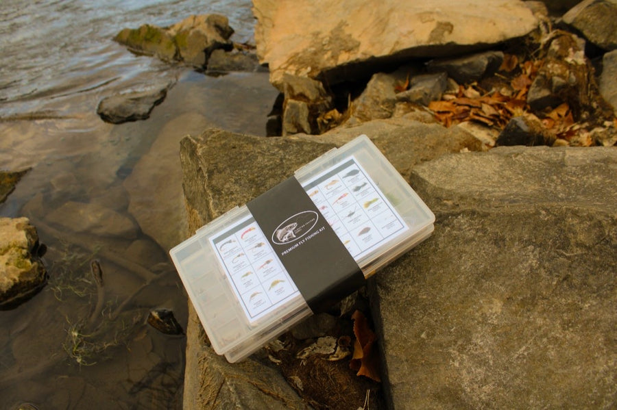 Premium fly fishing kit on the river rocks