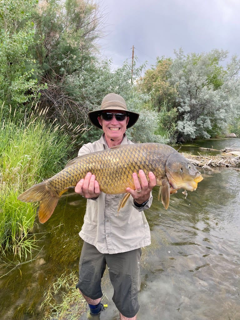 Angler with a catch on the river